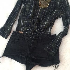 Black distressed button up Jean shorts.